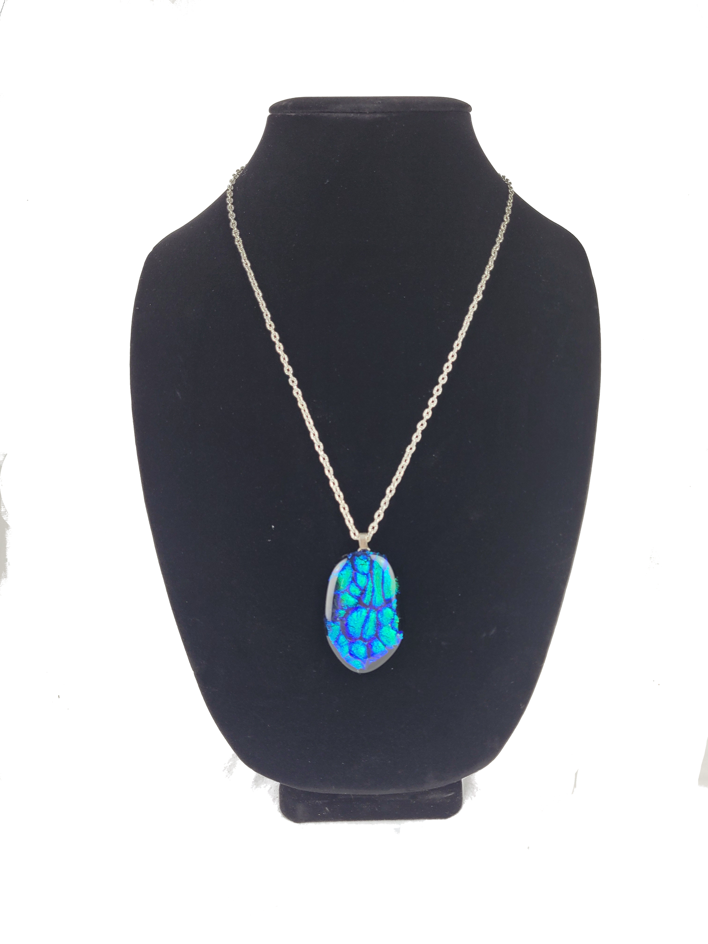 Necklace with a blue pendant on a black mannequin bust against a white background