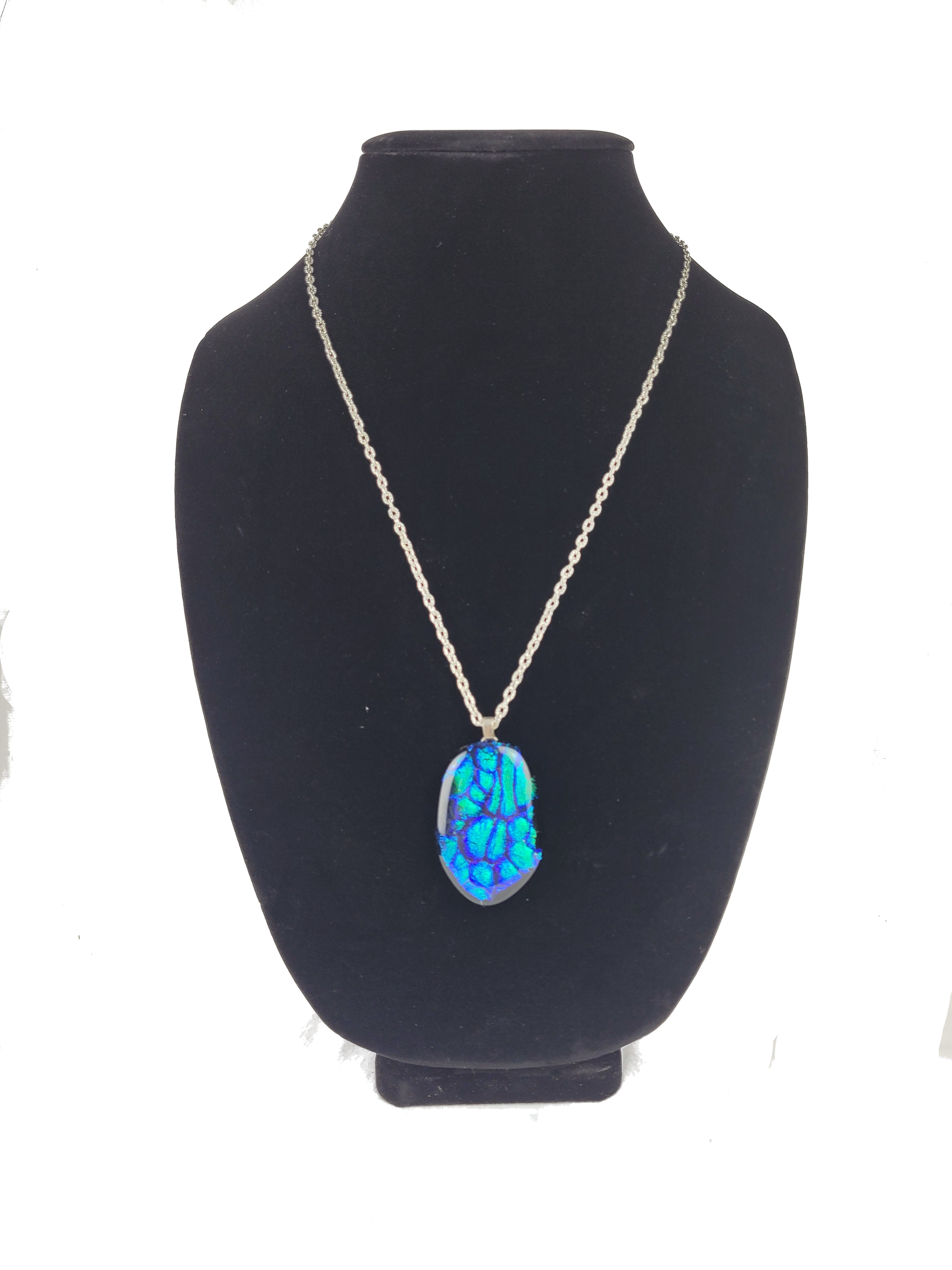 Necklace with a blue pendant on a black mannequin bust against a white background