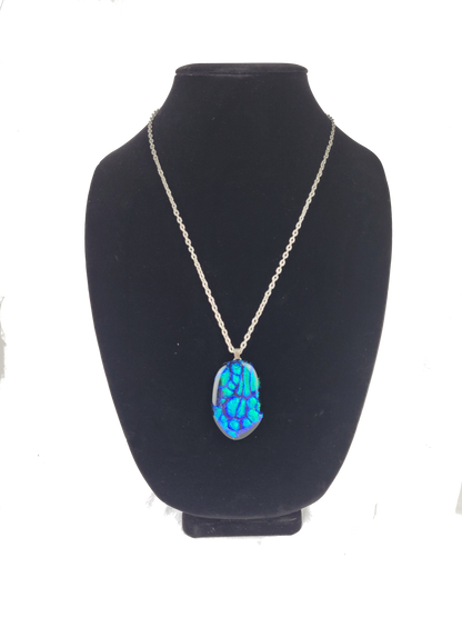 Necklace with a blue pendant on a black mannequin bust against a white background