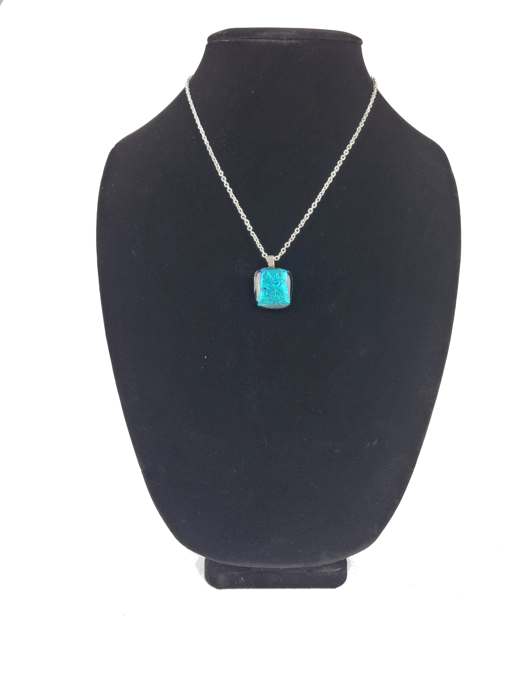Turquoise pendant necklace on a black bust
