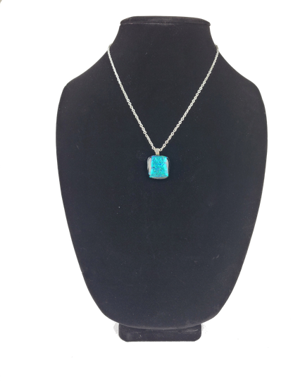 Turquoise pendant necklace on a black bust