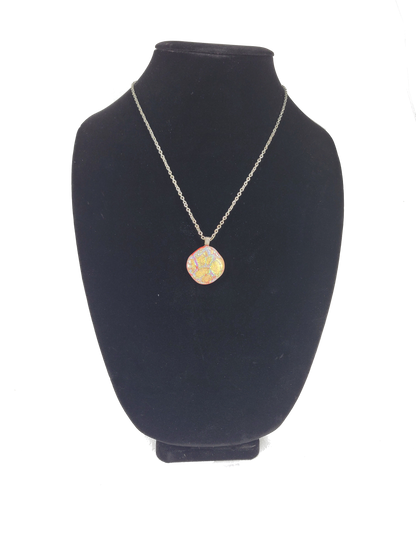 Necklace with a pendant on a black velvet stand against a white background