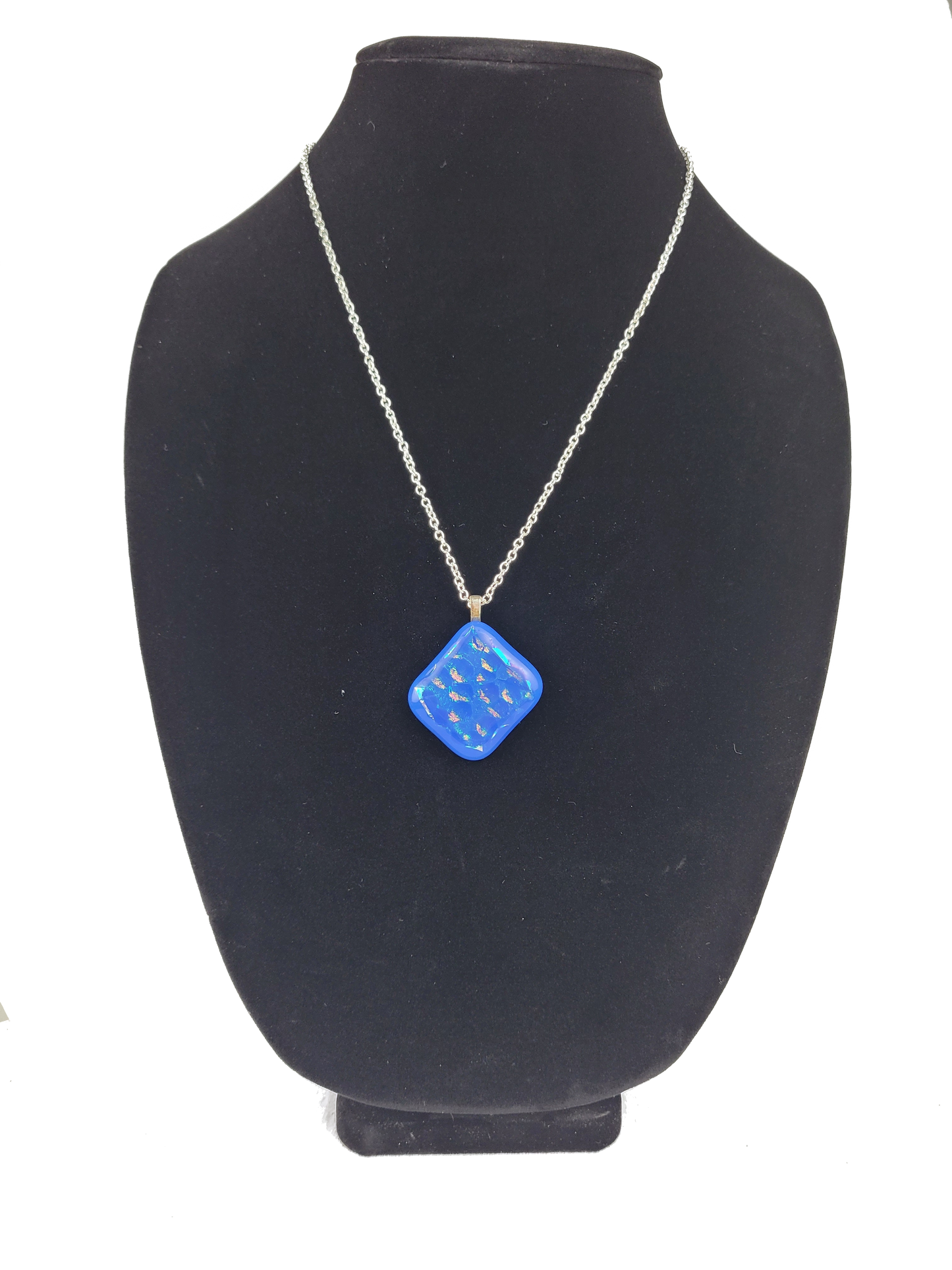 Blue pendant necklace on a black mannequin bust