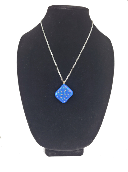 Blue pendant necklace on a black mannequin bust