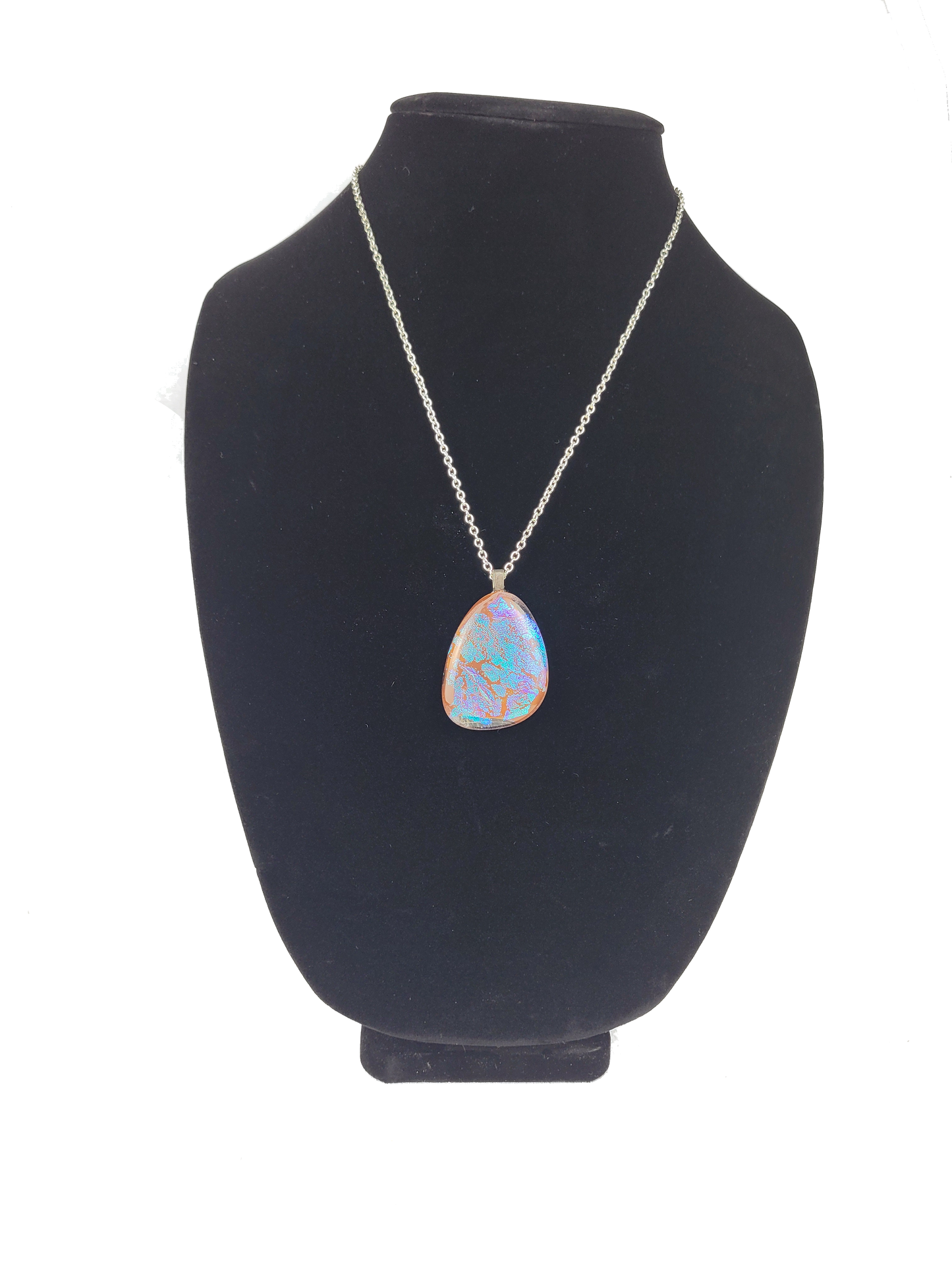 Necklace with a pendant on a black bust against a white background