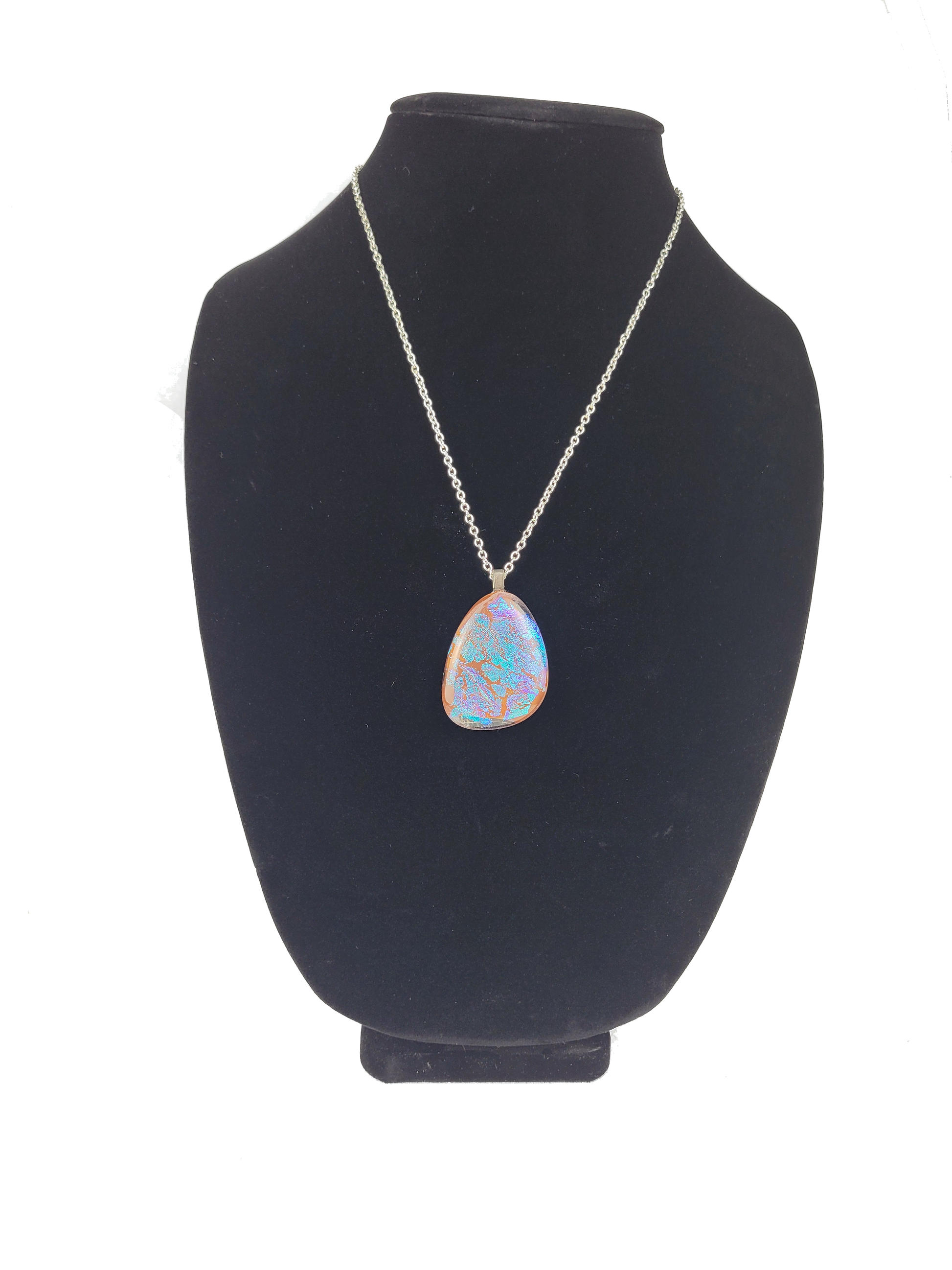 Necklace with a pendant on a black bust against a white background