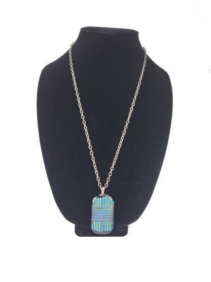 Necklace with a blue pendant on a black bust