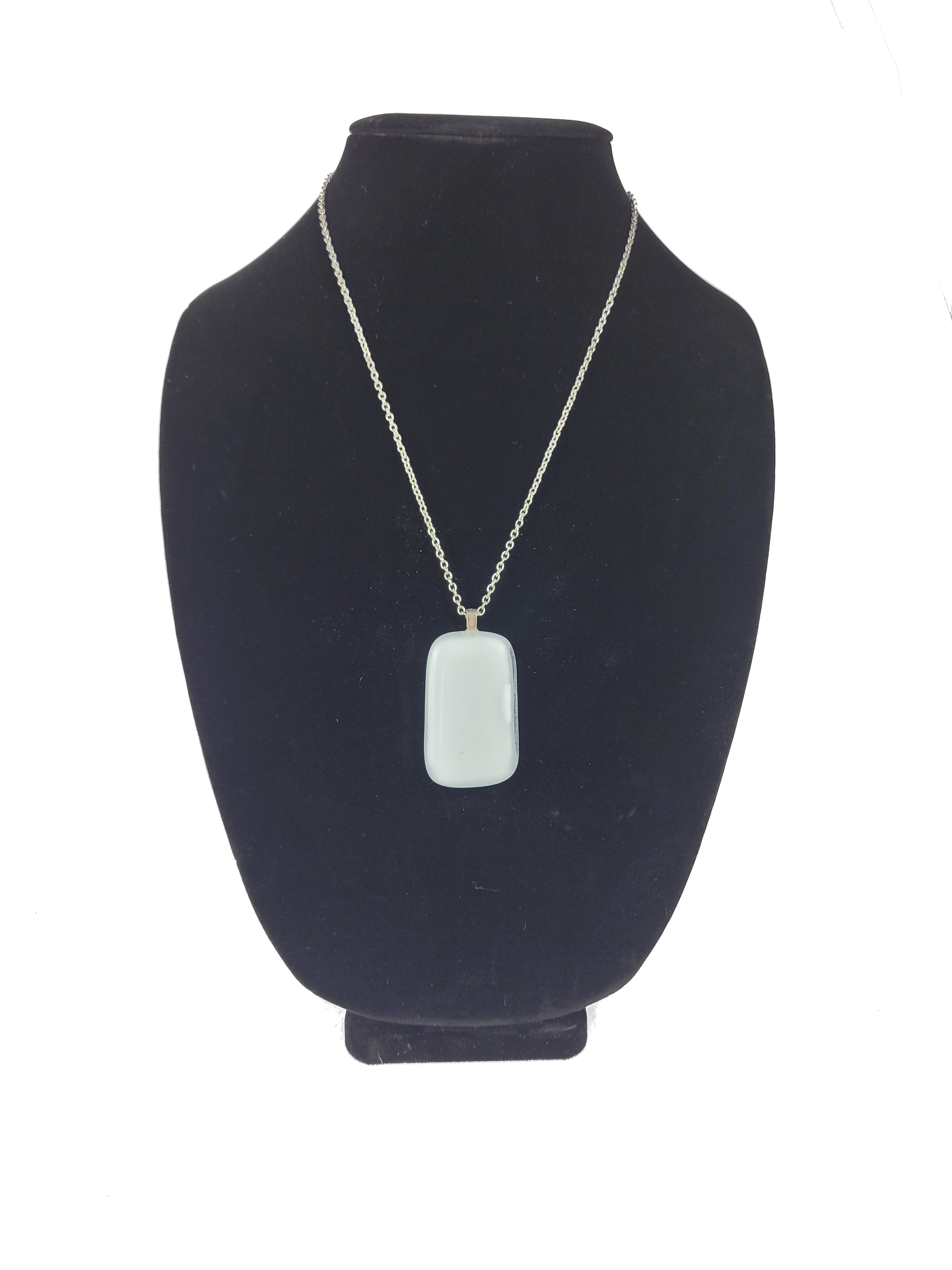 Necklace with a pendant on a black bust against a white background