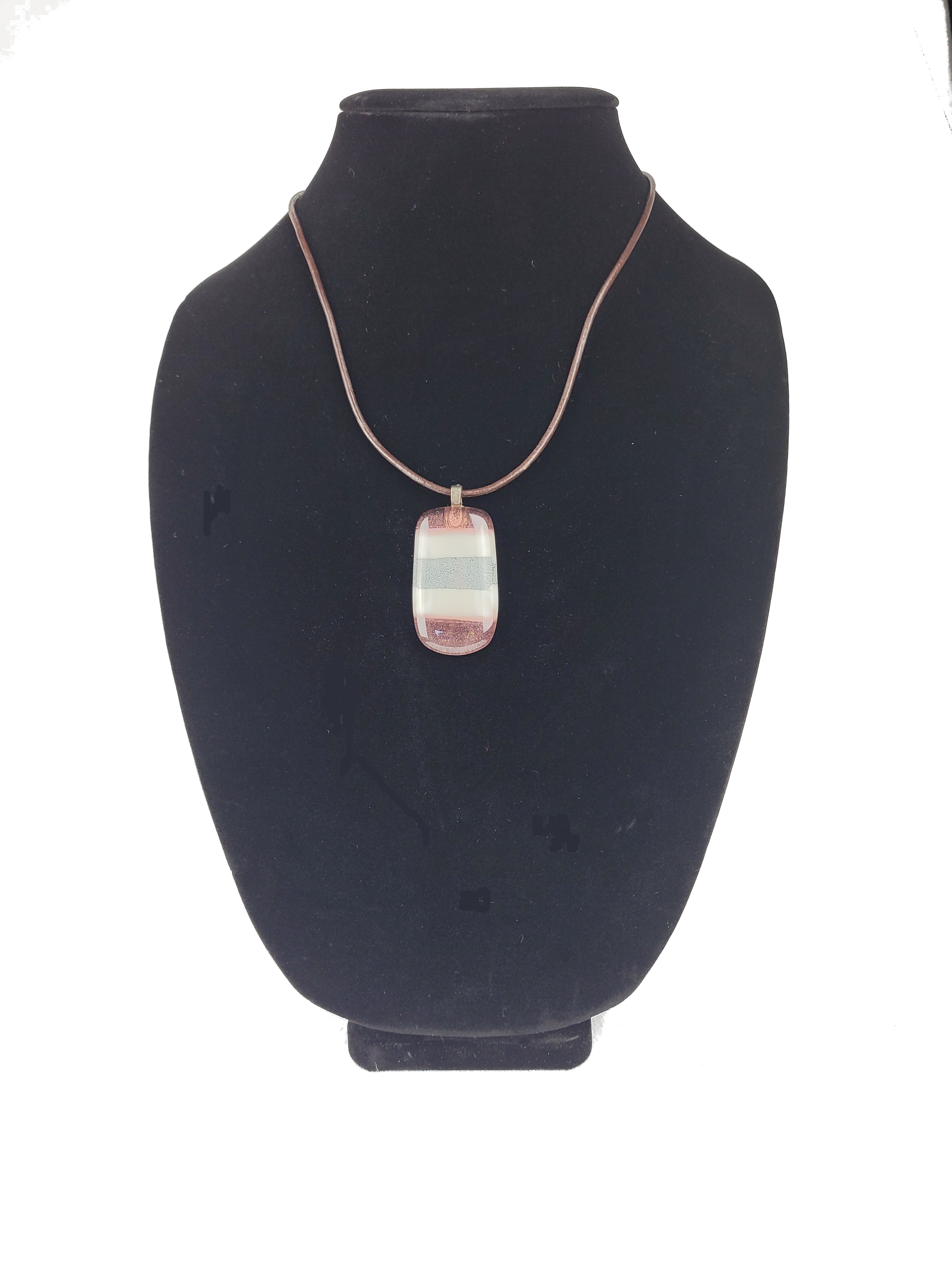 Necklace with a pendant on a black bust against a white background