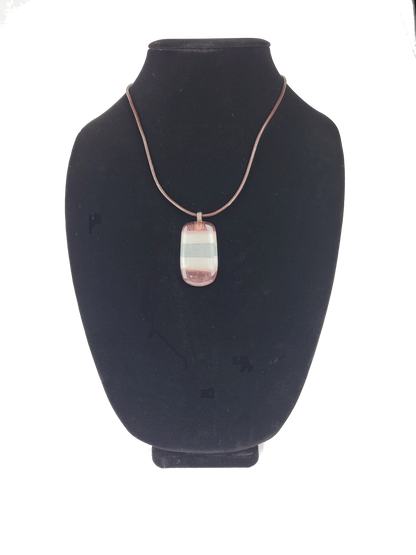 Necklace with a pendant on a black bust against a white background