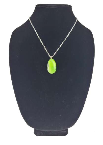Neon green pendant necklace on a black mannequin bust