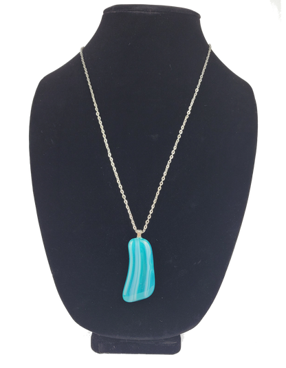 Turquoise pendant necklace on a black bust