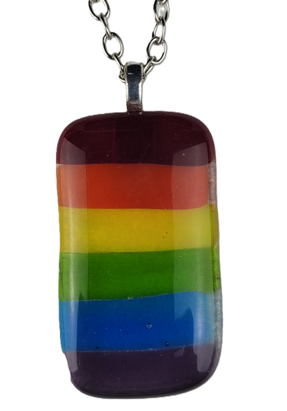 Rainbow striped pendant on a chain against a white background