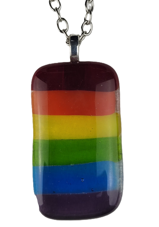 Rainbow striped pendant on a chain against a white background