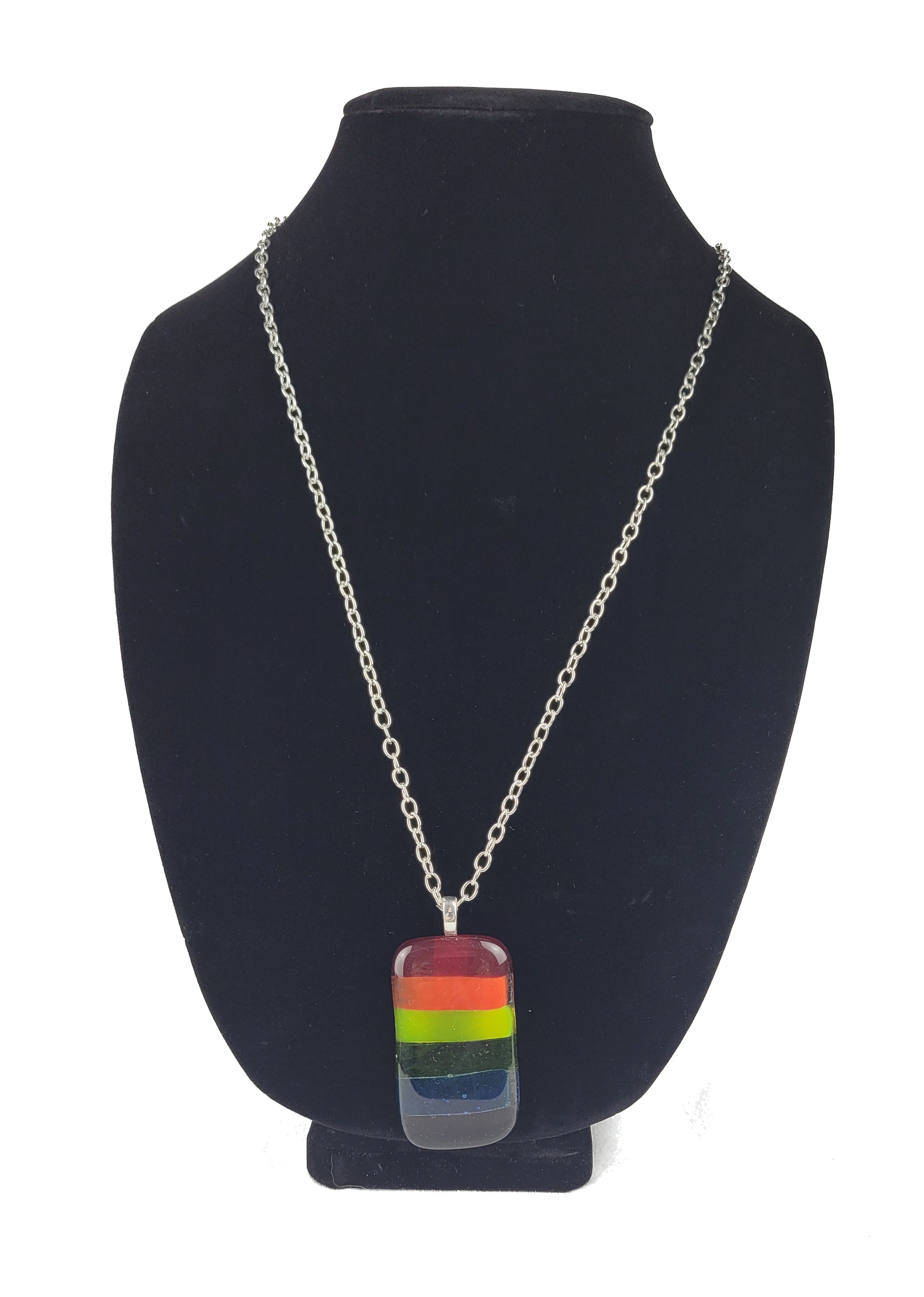 Necklace with a rainbow pendant on a black bust