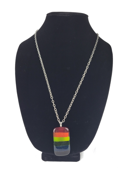 Necklace with a rainbow pendant on a black bust