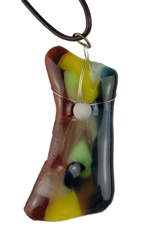 Colorful glass pendant on a cord against a white background