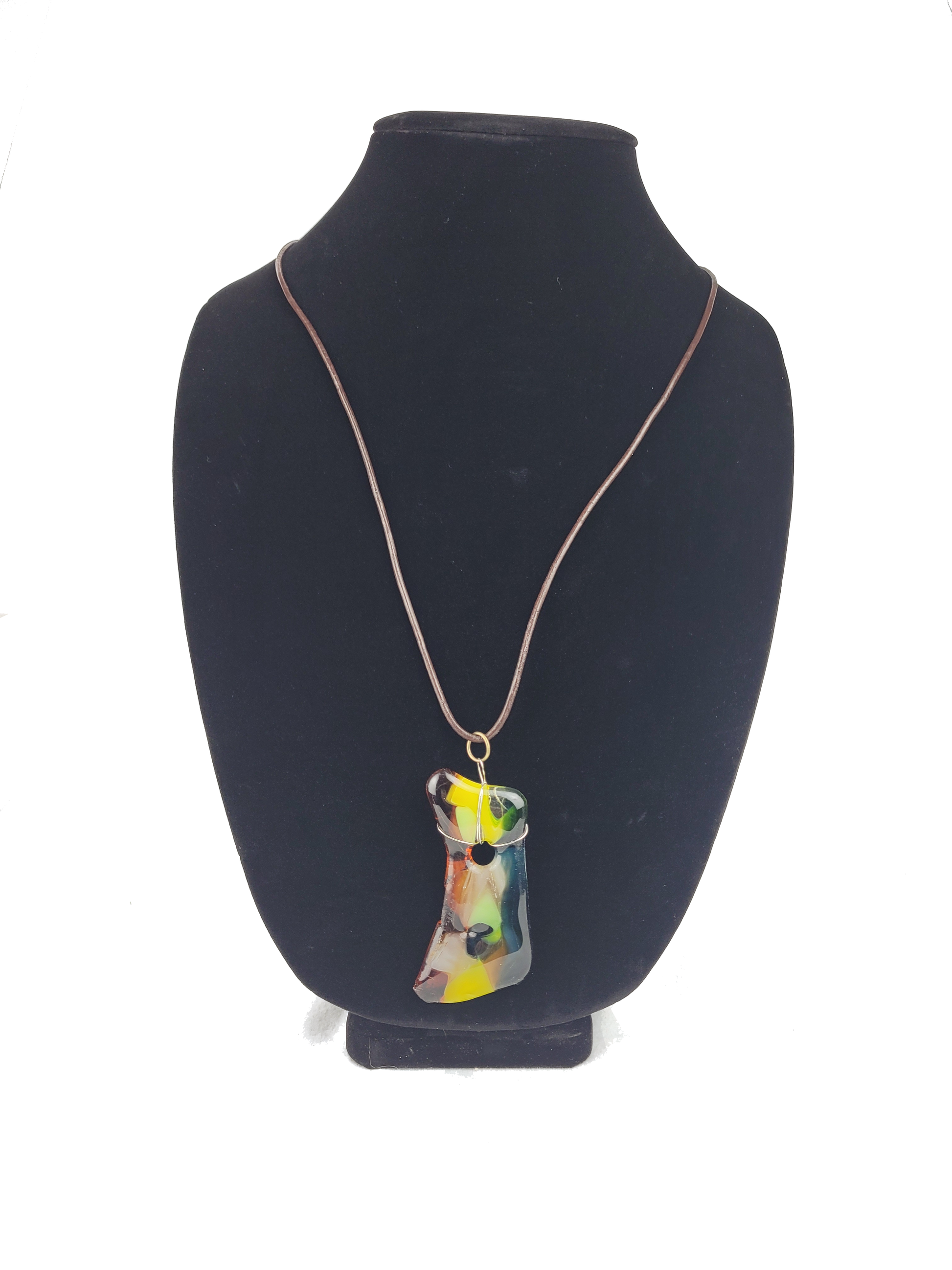 Necklace with a colorful pendant on a black bust against a white background