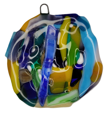 Colorful glass ornament with abstract design on a white background