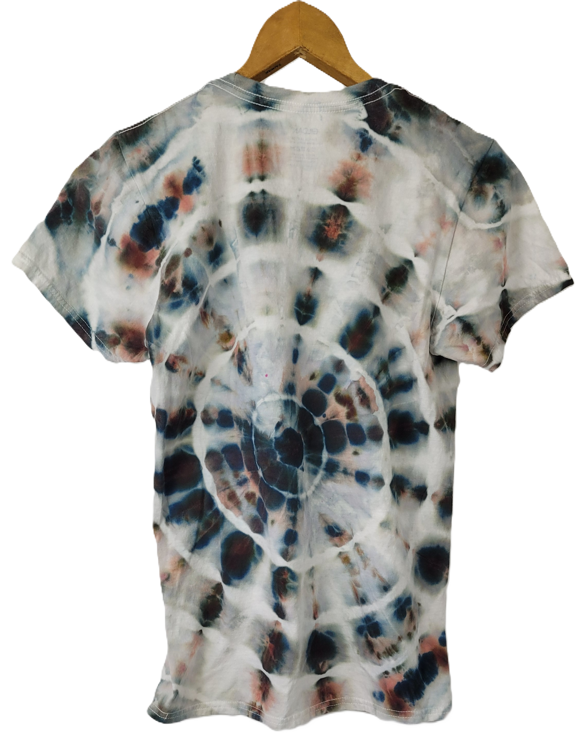 Tie-dye t-shirt on a wooden hanger with a white background