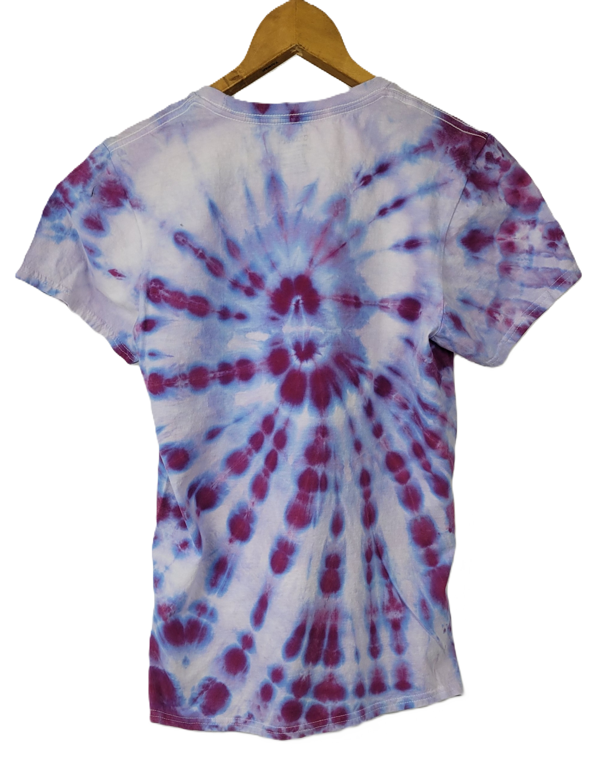 Tie-dye t-shirt with a spiral pattern on a hanger against a white background