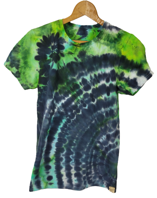 Tie-dye t-shirt with green and blue patterns on a hanger