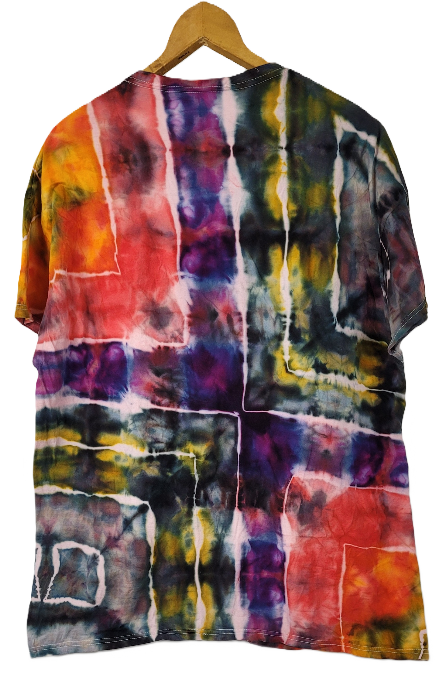 Multicolored tie-dye shirt on a wooden hanger against a white background