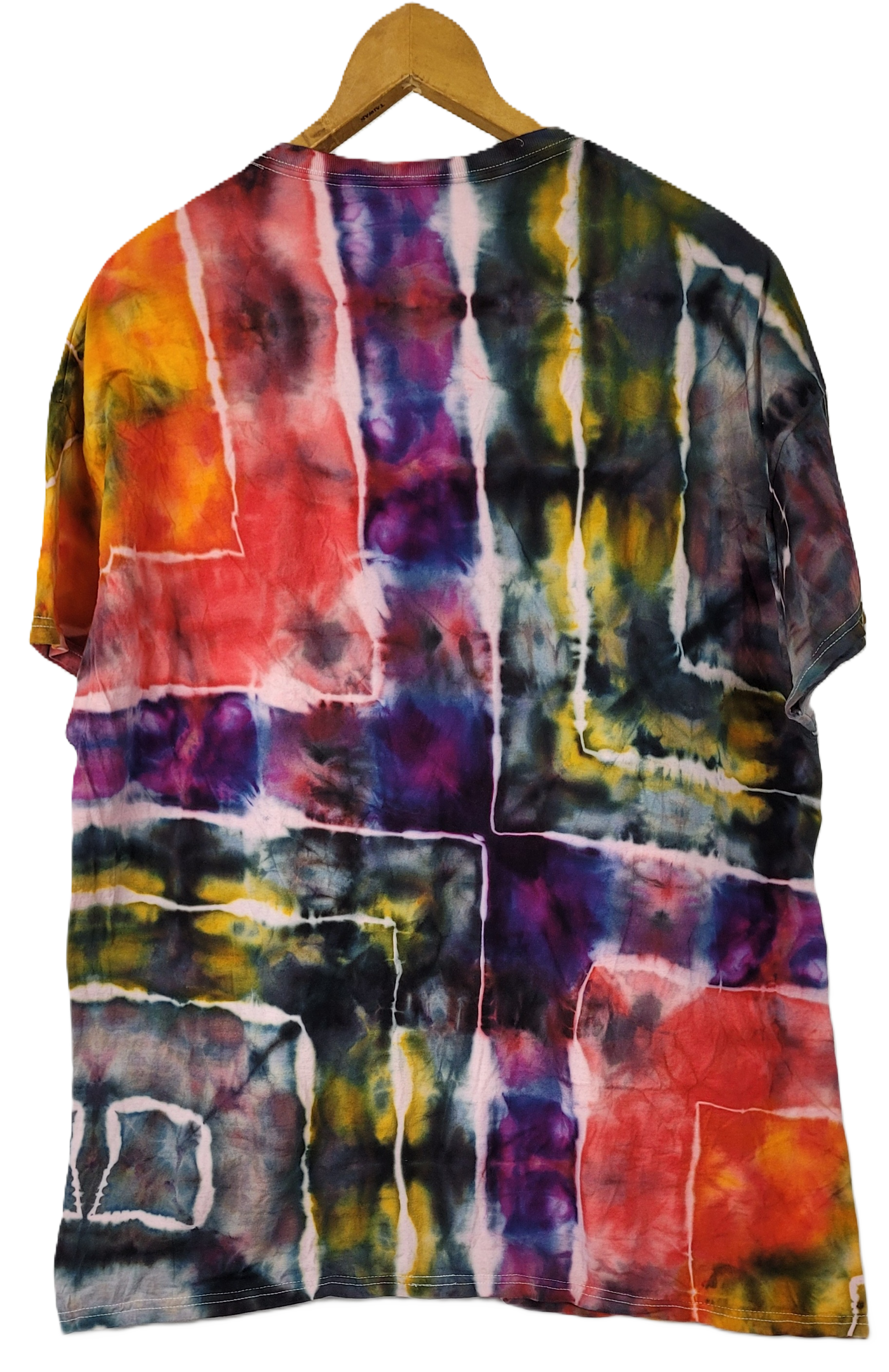 Multicolored tie-dye shirt on a wooden hanger against a white background