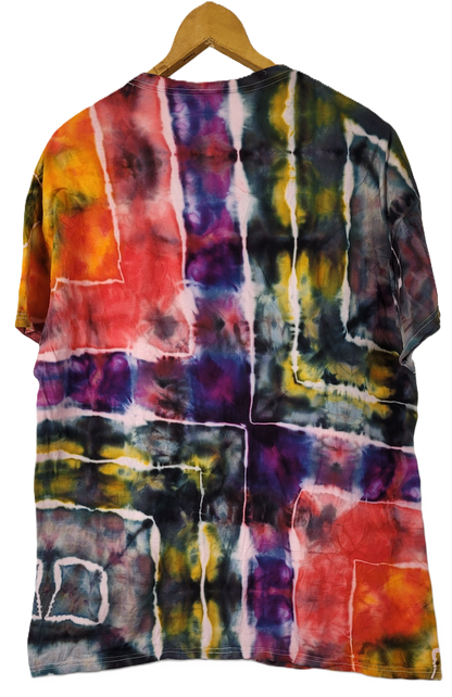 Multicolored tie-dye shirt on a wooden hanger against a white background
