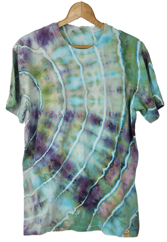 Colorful tie-dye shirt on a wooden hanger against a white background