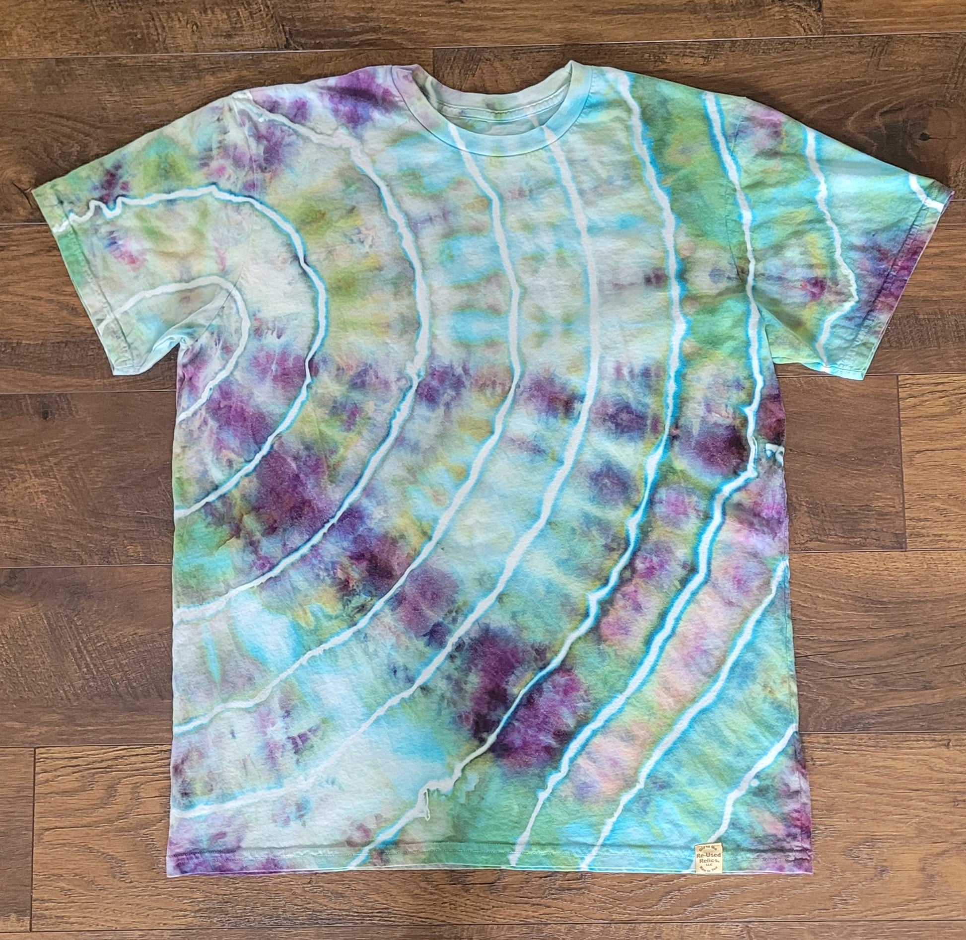 Tie-dye t-shirt with wavy patterns on a wooden surface