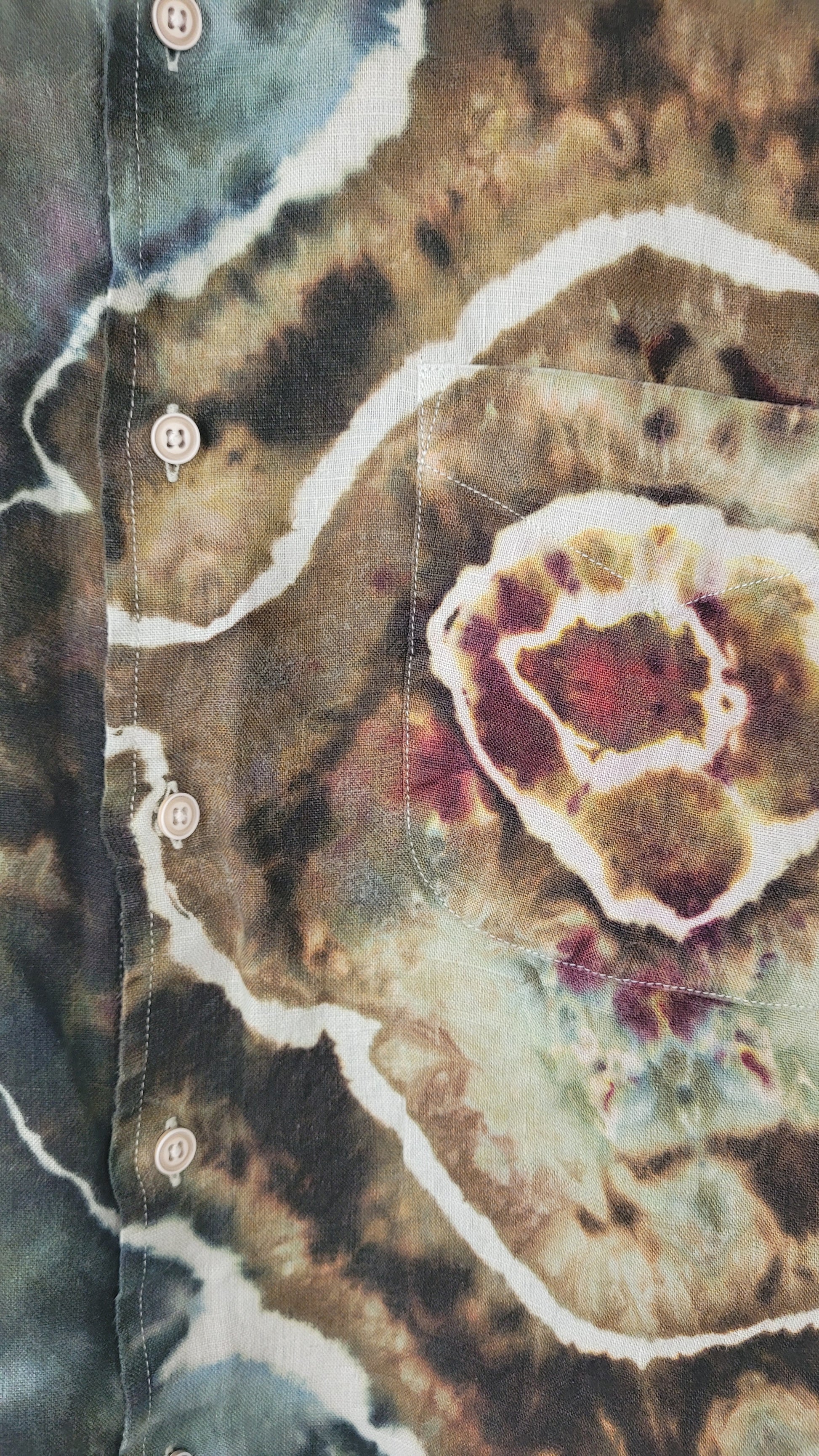 Close-up of a patterned fabric with earthy tones and white accents