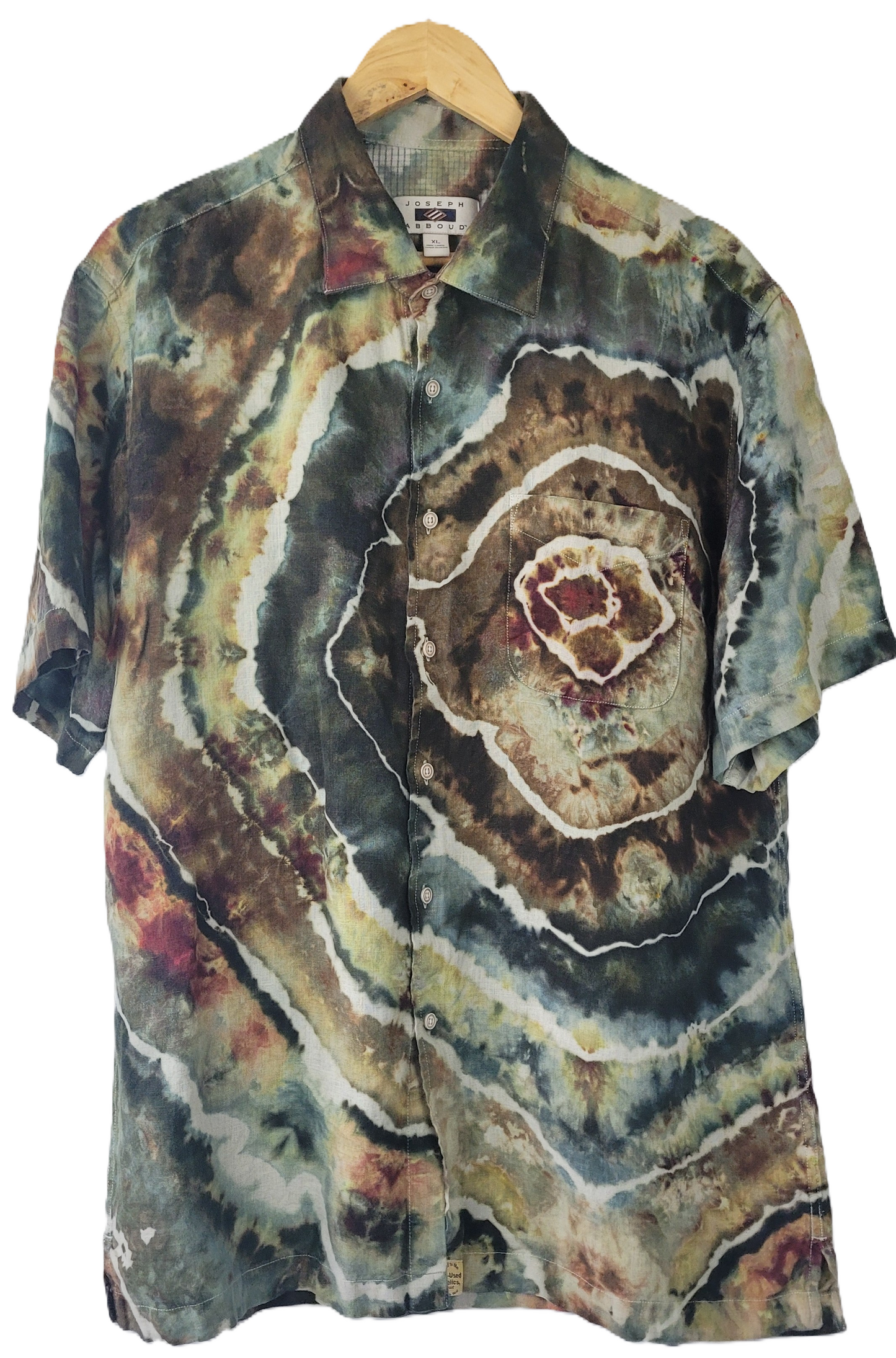 Colorful tie-dye shirt on a hanger with a white background