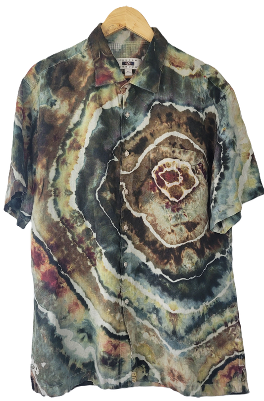 Colorful tie-dye shirt on a hanger with a white background