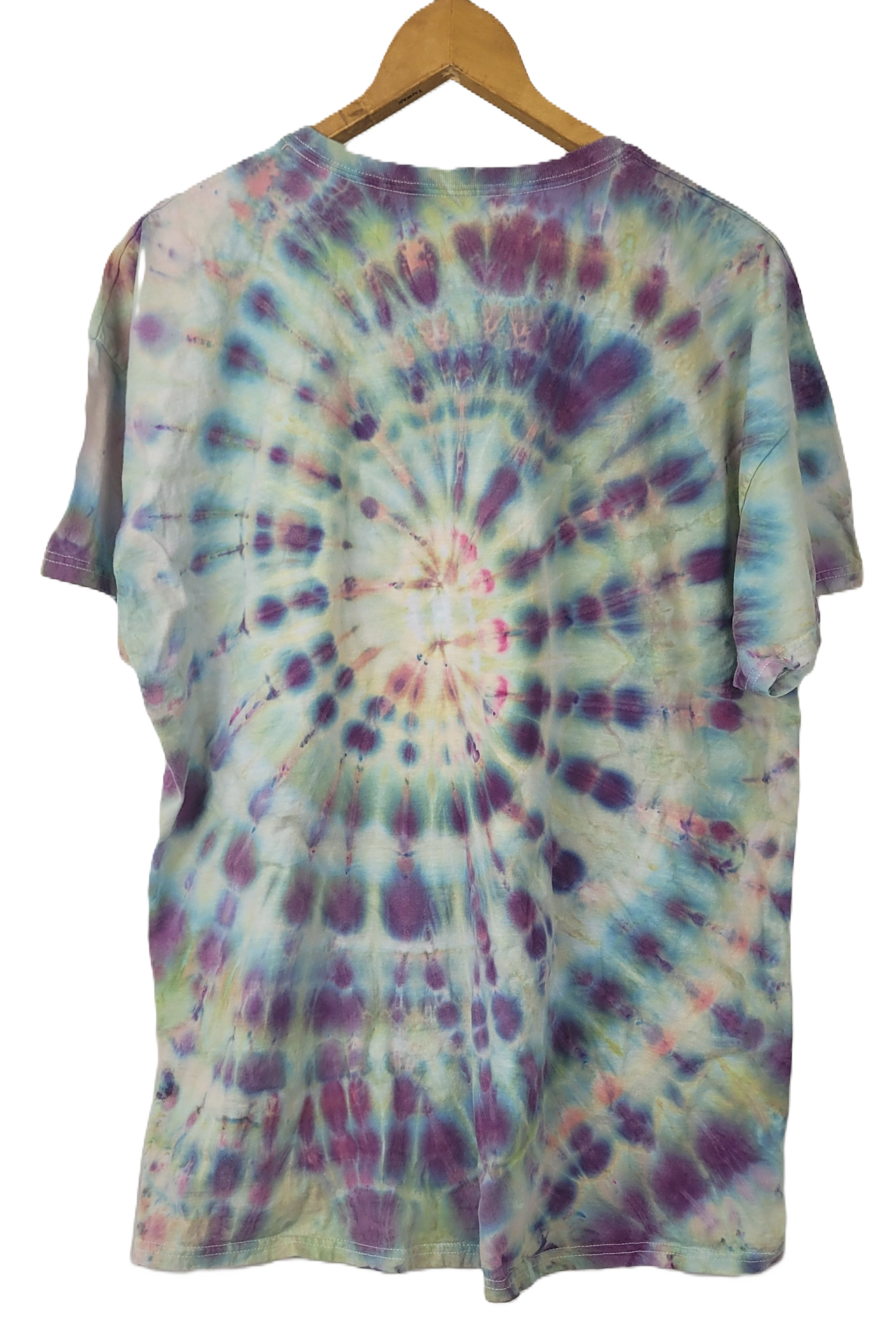 Tie-dye t-shirt on a wooden hanger with a white background