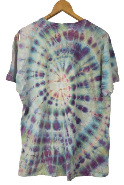 Tie-dye t-shirt on a wooden hanger with a white background