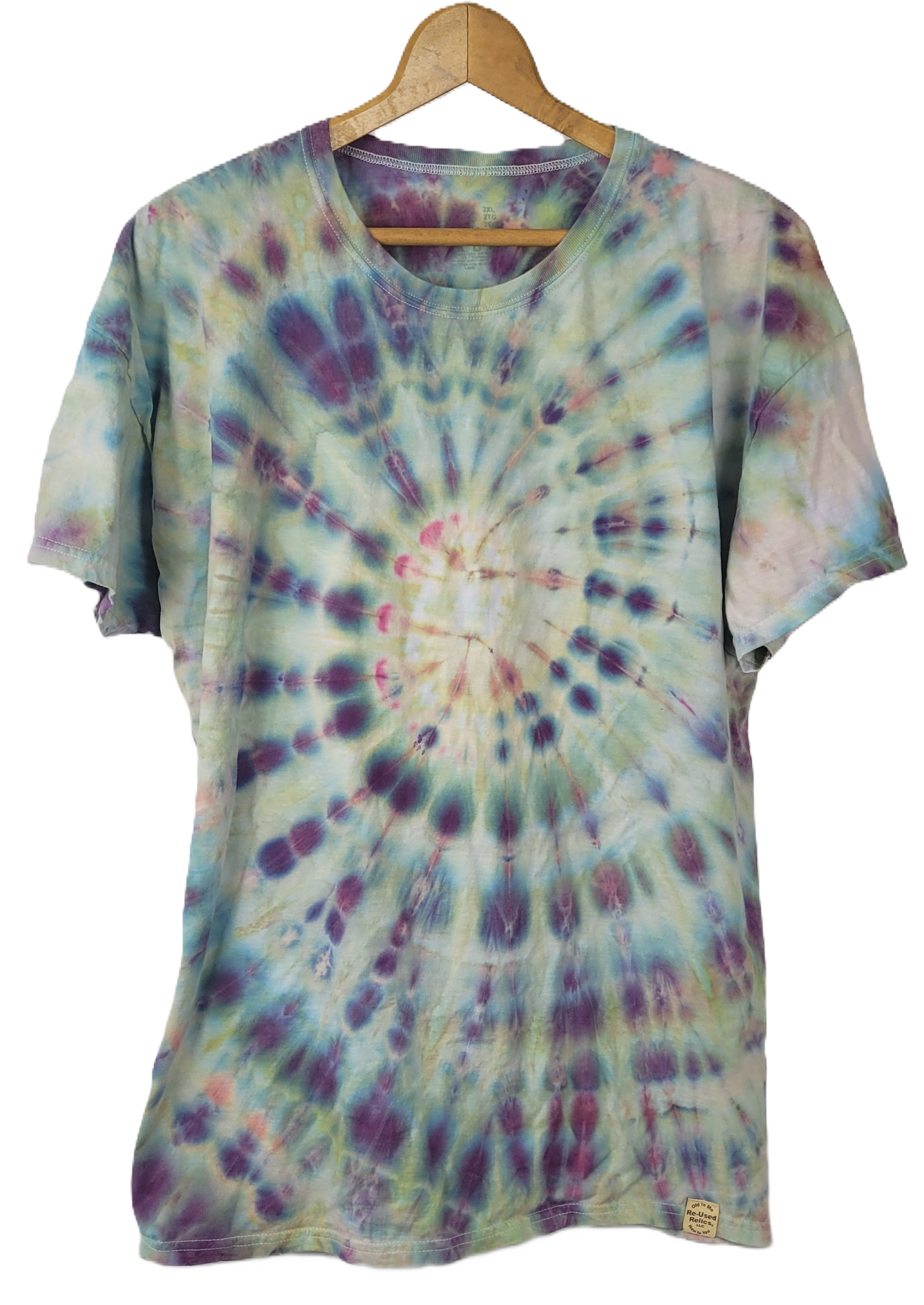 Tie-dye t-shirt on a wooden hanger with a white background