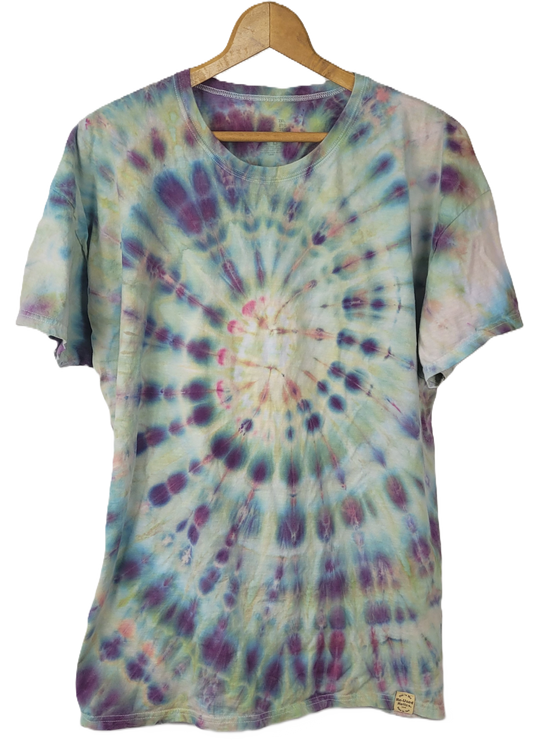 Tie-dye t-shirt on a wooden hanger with a white background