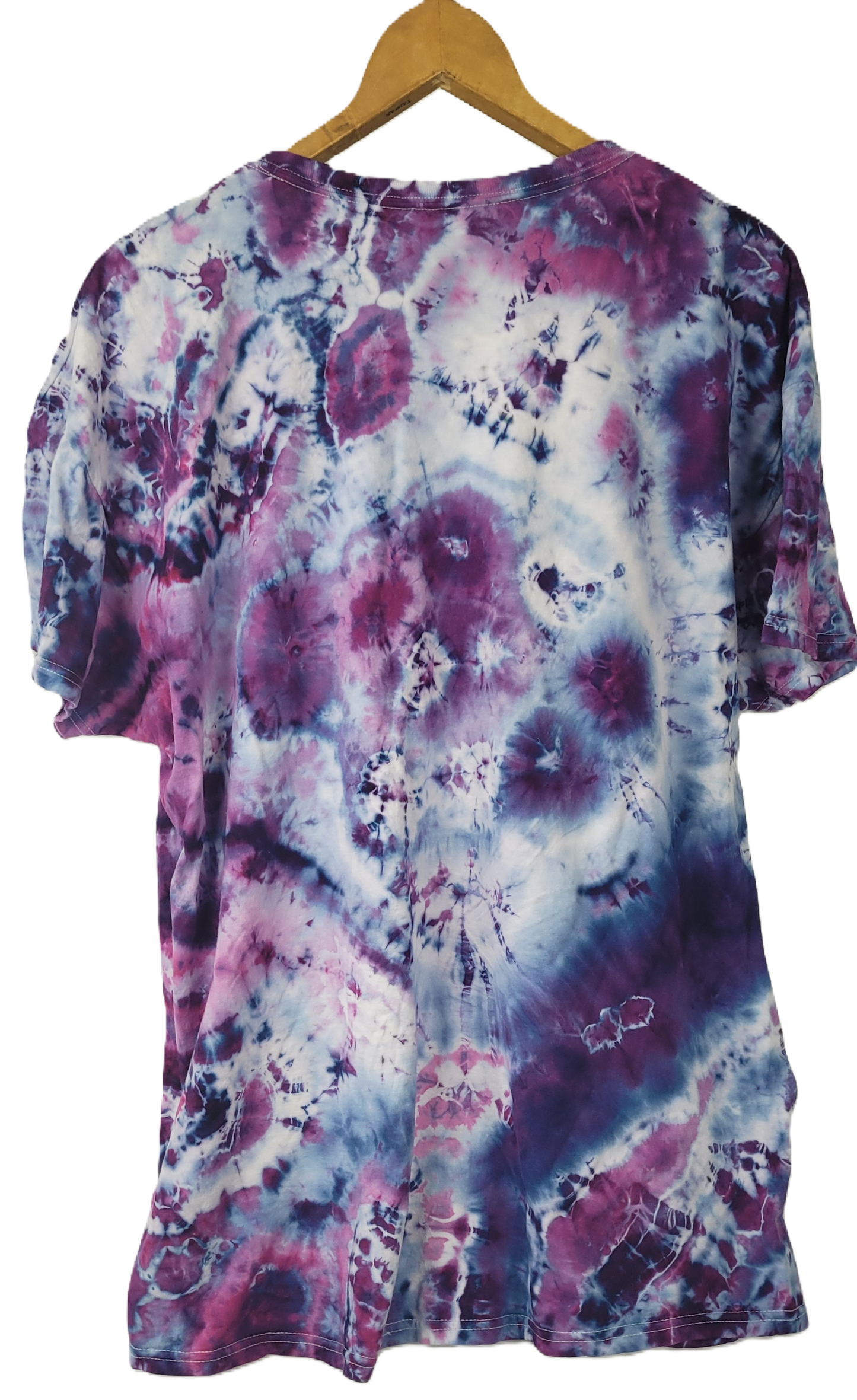 Tie-dye shirt with purple and pink patterns on a hanger