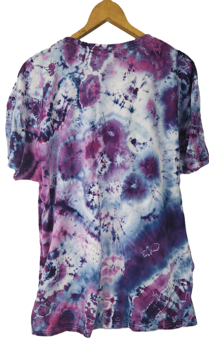 Tie-dye shirt with purple and pink patterns on a hanger