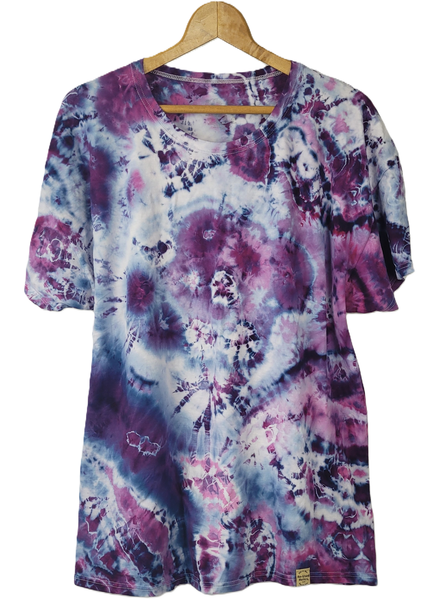 Tie-dye shirt with purple and pink patterns on a hanger