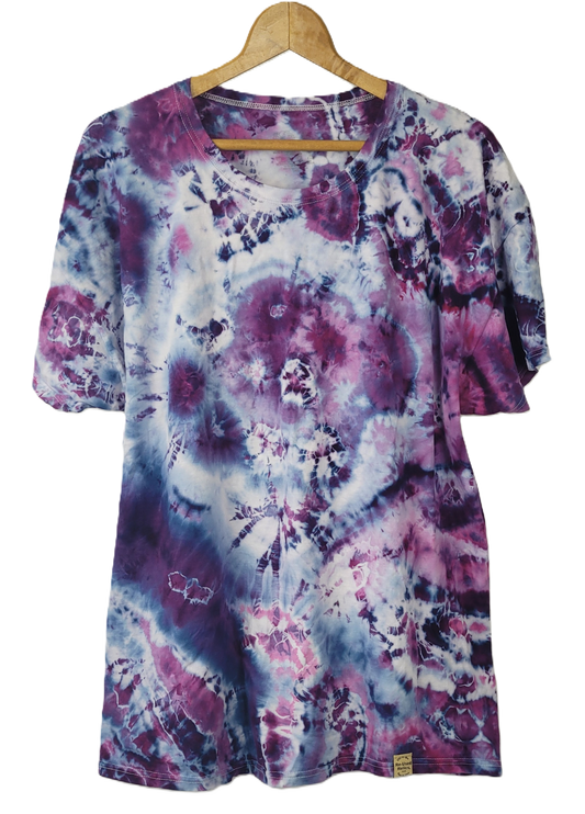 Tie-dye shirt with purple and pink patterns on a hanger