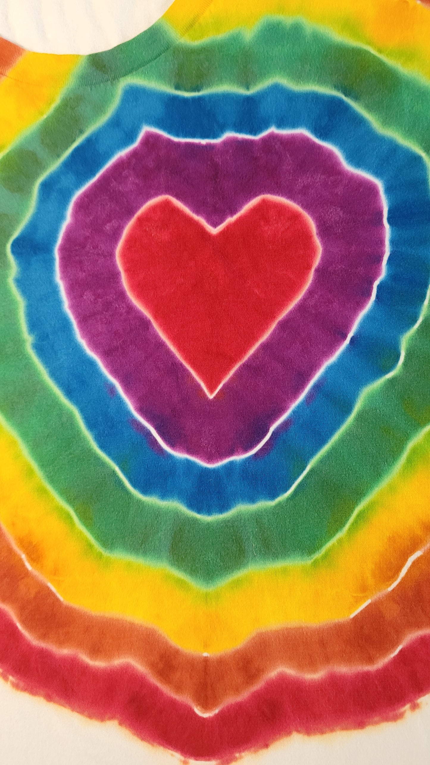 Colorful tie-dye pattern with a heart shape in the center