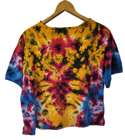 Colorful tie-dye shirt on a wooden hanger against a white background