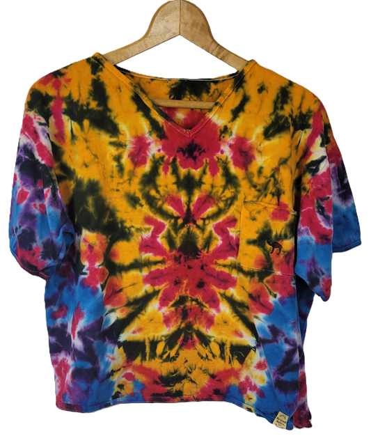 Colorful tie-dye shirt on a wooden hanger against a white background