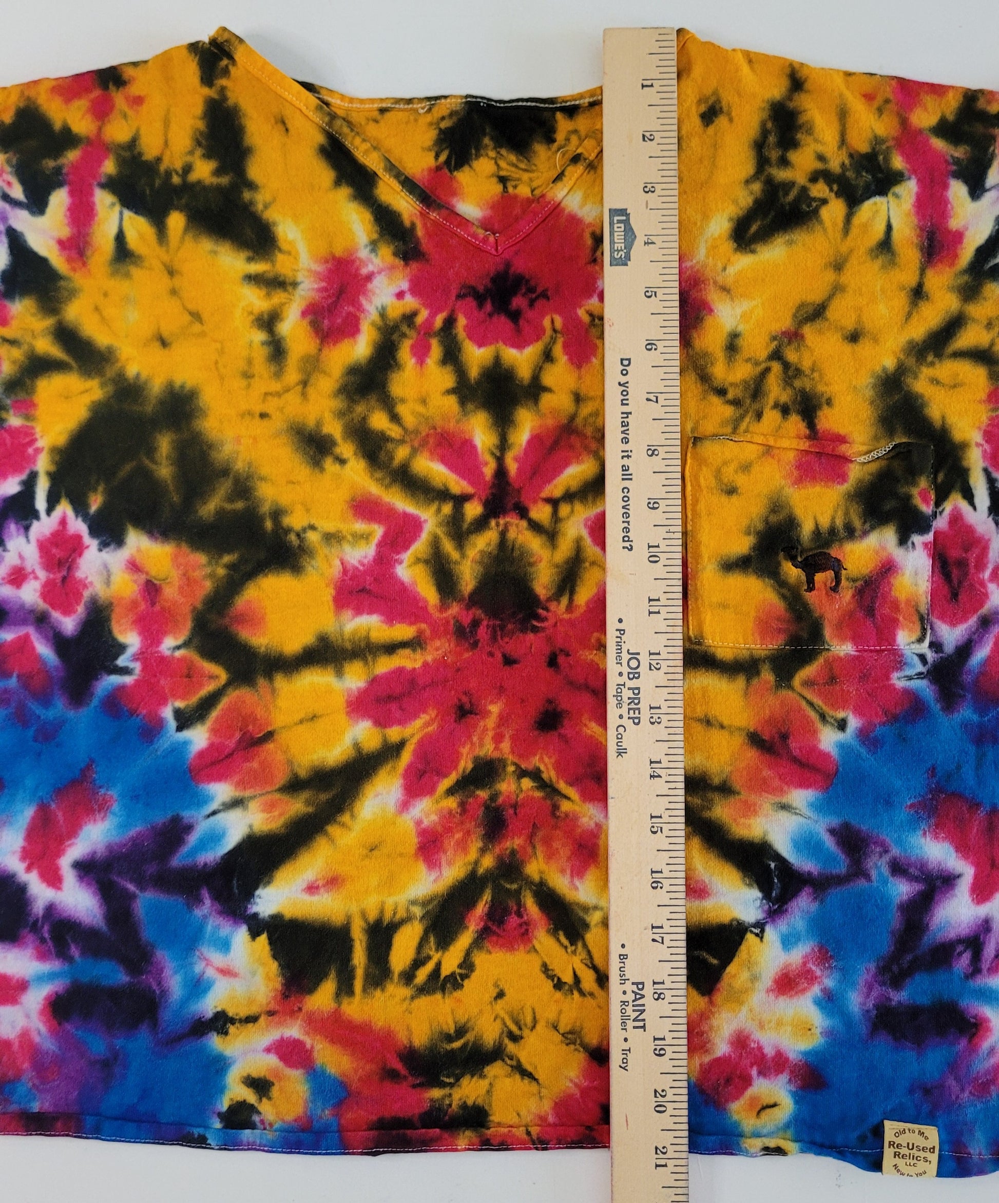Tie-dye fabric with a ruler for scale on a white background