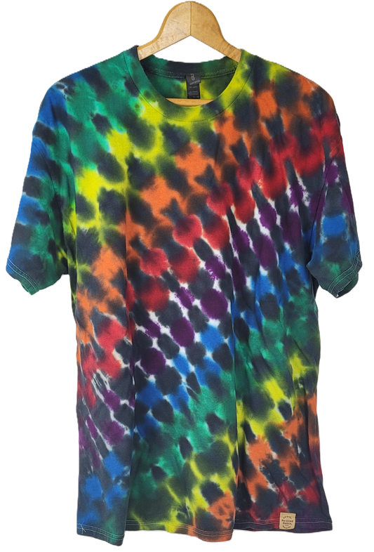 Multicolored tie-dye t-shirt on a hanger against a white background