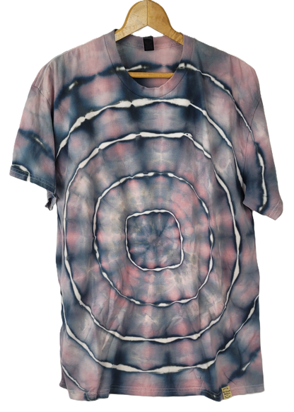 Tie-dye t-shirt with concentric circle pattern on a hanger