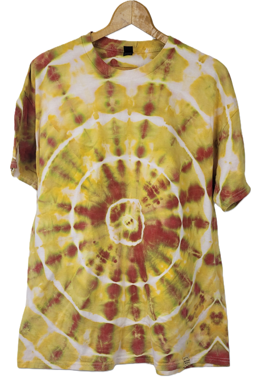 Tie-dye t-shirt with yellow and red spiral pattern on a hanger against a white background
