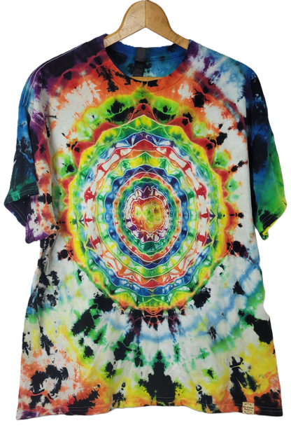 Colorful tie-dye t-shirt on a wooden hanger with a plain background